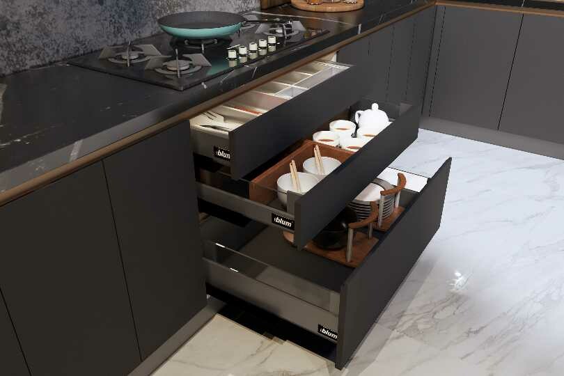 L-shaped kitchen with dark grey and marble countertop